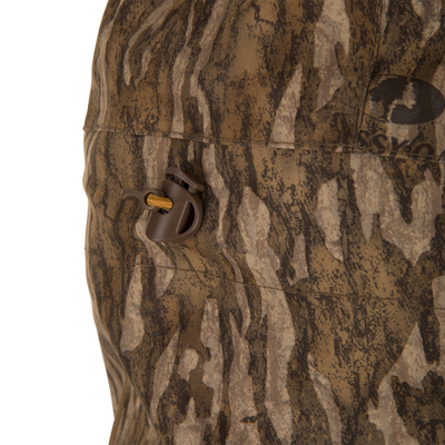 Close-up of LST BMF Eqwader Full Zip with Primaloft, showcasing wood-grain camo fabric and plastic cord lock on the drawstring for outdoor weather protection.
