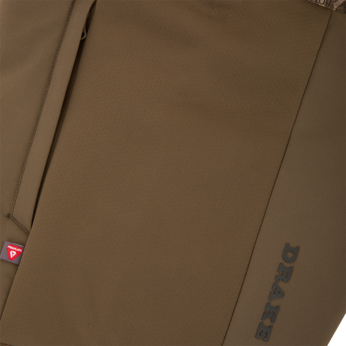 LST BMF Eqwader Full Zip with Primaloft showing zippered pocket with PrimaLoft tag and DRAKE branding, highlighting its technical features for outdoor adventures.