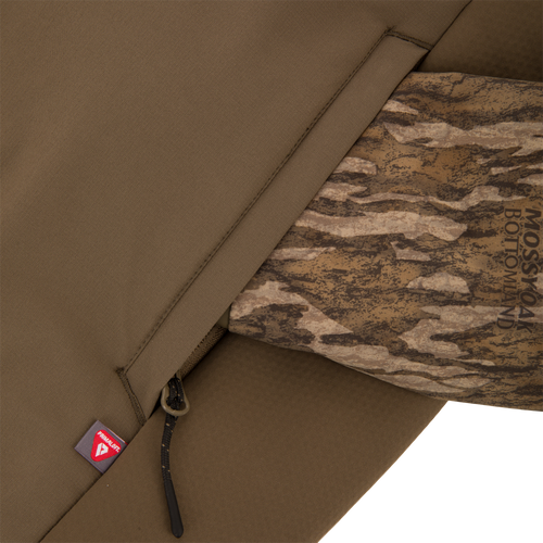 LST BMF Eqwader Half Zip Jacket featuring a zip-pocket with drawcord, Primaloft tag, and camo-lined interior, highlighting its functional design for hunting.