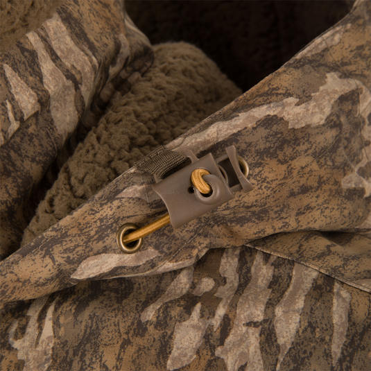 LST BMF Eqwader Half Zip Jacket with Primaloft, featuring a camouflage hood with adjustable drawstring, plastic cord lock, and soft fleece lining for warmth.