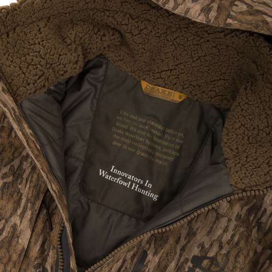 Close-up of the LST BMF Eqwader Half Zip Jacket's interior, highlighting the sherpa fleece collar, zippered front, and Drake Waterfowl label with heritage details.