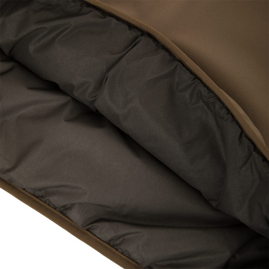Close-up of the LST BMF Eqwader Half Zip Jacket showing its brown shell and quilted insulated lining for warmth and protection in harsh weather.
