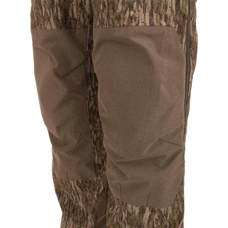 Close-up of LST BMF Pit Bib highlighting camo design, reinforced knee panels, and side zipper, showcasing durable construction and weather protection for rugged hunting conditions.