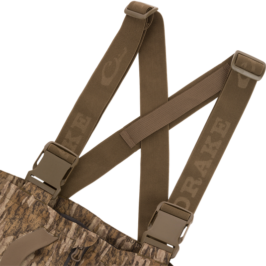 LST BMF Pit Bib with Primaloft features camo fabric, adjustable olive-brown suspenders with quick-release buckles, and a zippered fly for rugged outdoor performance.