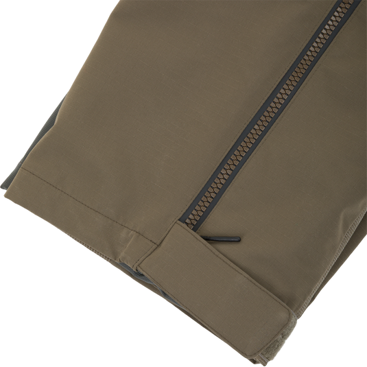 Olive drab Drake X Ducks Unlimited LST BMF Pit Bib with Primaloft pant leg featuring a side zipper and a hook-and-loop tab at the ankle.