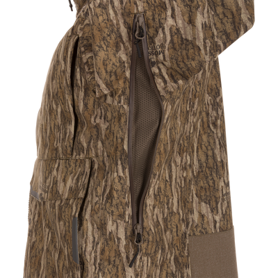 Close-up of the LST BMF Pit Jacket, highlighting its camouflage pattern, two-way zipper with mesh vent, and flap pocket for extreme hunting conditions.