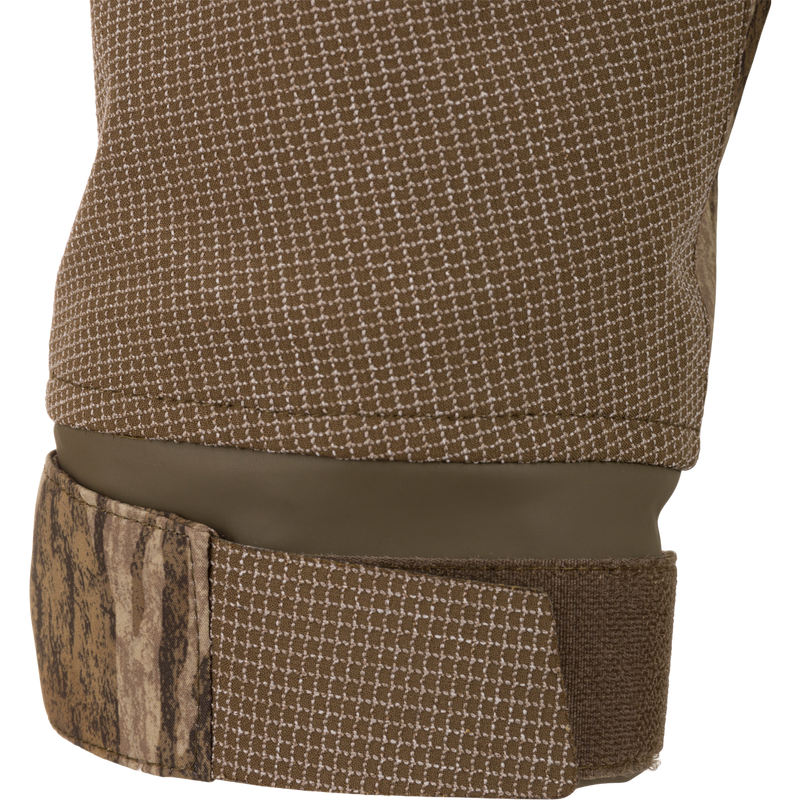 Close-up of the LST BMF 3-in-1 Pit Jacket's neoprene-lined camouflage cuff with Velcro adjustment, highlighting its waterproof design for hunting and outdoor durability.