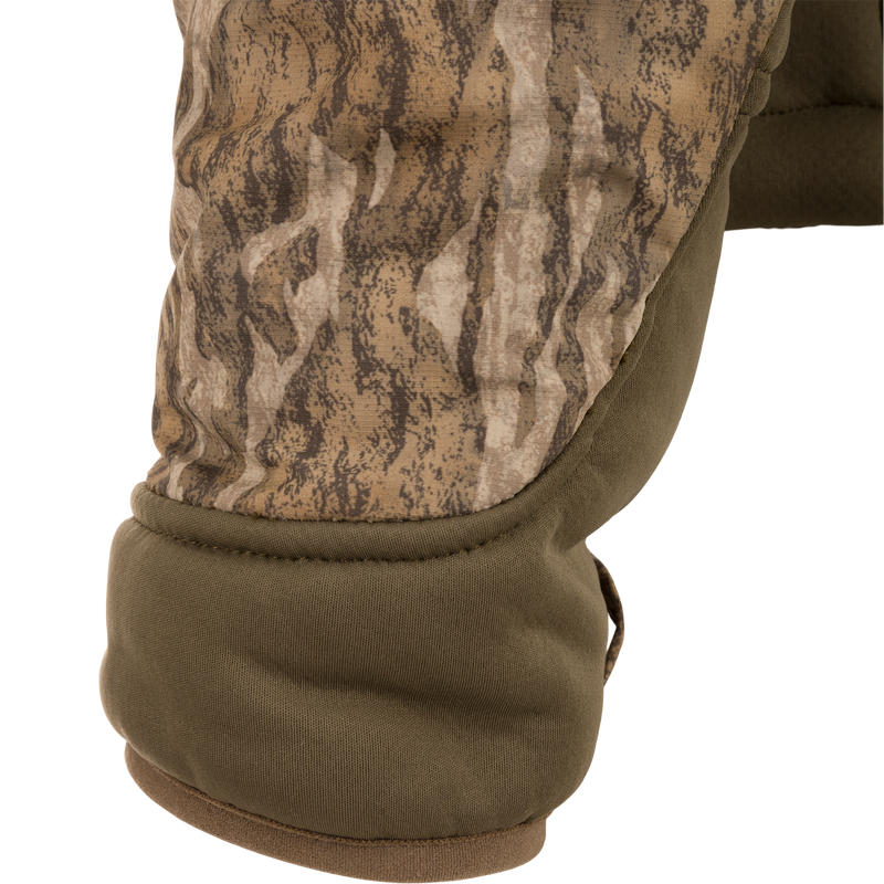 Close-up of the LST BMF 3-in-1 Pit Jacket, showcasing padded camouflage elbow and olive-green quilted fabric, emphasizing durability and versatility for hunting conditions.
