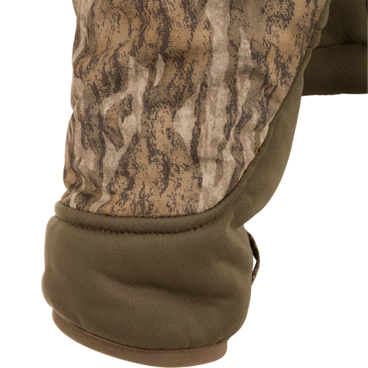 Close-up of the LST BMF 3-in-1 Pit Jacket, showcasing padded camouflage elbow and olive-green quilted fabric, emphasizing durability and versatility for hunting conditions.