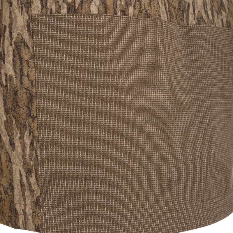Close-up of the LST BMF 3-in-1 Pit Jacket with Primaloft, showcasing tree-bark camouflage and fine grid pattern fabrics, highlighting its rugged and versatile design.