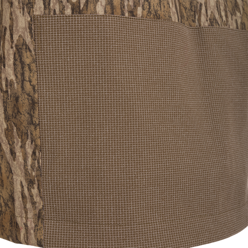 Close-up of the LST BMF 3-in-1 Pit Jacket with Primaloft, showcasing tree-bark camouflage and fine grid pattern fabrics, highlighting its rugged and versatile design.