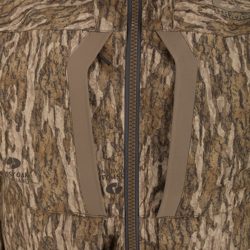 LST BMF 3-in-1 Pit Jacket featuring a central zipper, angled chest-pocket openings, and Mossy Oak/Drake branding in a tree-bark camo pattern.