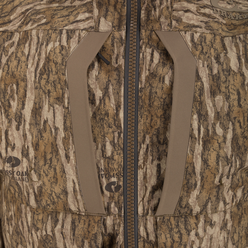 LST BMF 3-in-1 Pit Jacket featuring a central zipper, angled chest-pocket openings, and Mossy Oak/Drake branding in a tree-bark camo pattern.