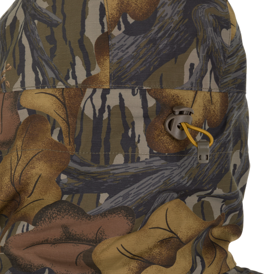 Close-up of the Drake X Ducks Unlimited LST BMF 3-in-1 Pit Jacket with Primaloft hood, featuring an adjustable yellow drawstring cord and toggle.