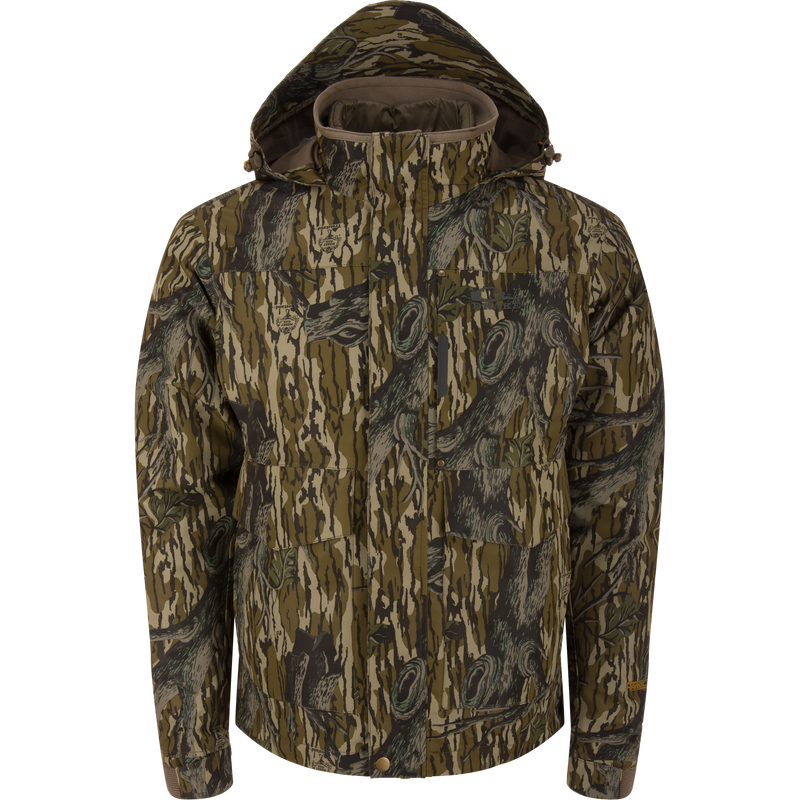 LST Hardline 3-in-1 Jacket in tree-bark camouflage, featuring a hood, high collar, zip-and-snap front, multiple pockets, and adjustable cuffs for versatile hunting protection.