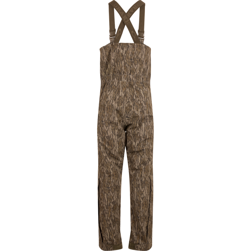 LST Hardline Insulated Bib, camouflage-patterned, features adjustable suspenders, waterproof polyester, synthetic down insulation, YKK zippers, and articulated knees, ideal for harsh outdoor conditions.