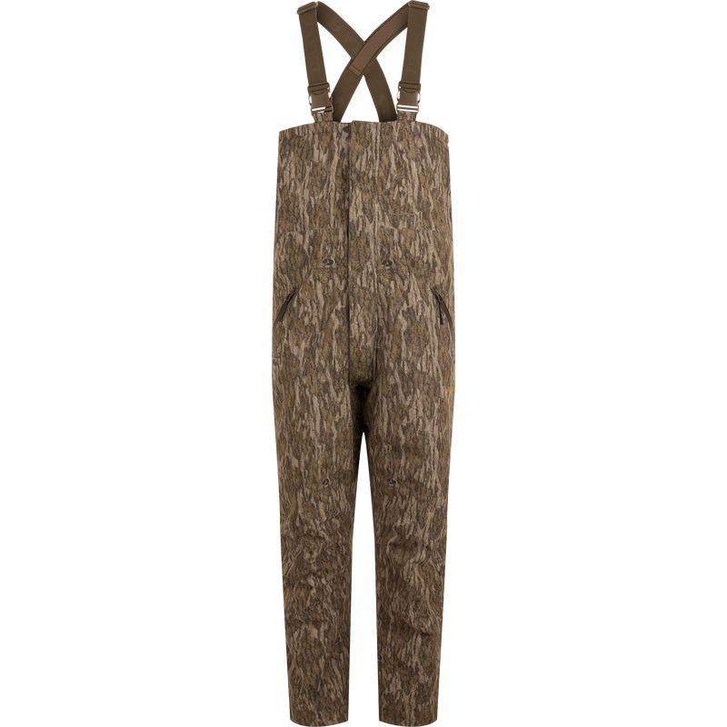 LST Hardline Insulated Bib designed for wooded hunting, features durable waterproof fabric, synthetic insulation, and functional zippers for easy wear in harsh environments.