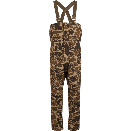 LST Hardline Insulated Bib with camo pattern, adjustable suspenders, and storm-resistant zippers, designed for warmth and mobility in harsh outdoor conditions.