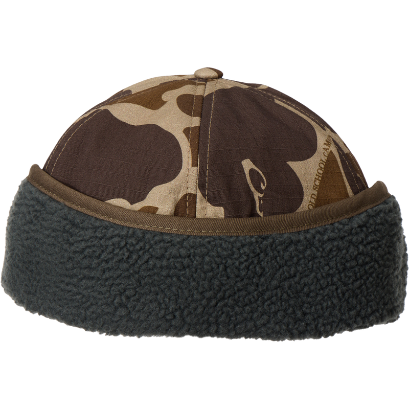 MST Flap Cap with camouflage print, dark gray sherpa cuff, and fold-down ear flaps, ideal for outdoor adventures in cold weather.