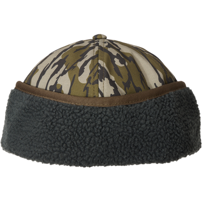 MST Flap Cap with camo crown and fleece brim, featuring sherpa-lined ear flaps and adjustable clasp for outdoor cold-weather comfort.