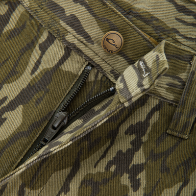 Close-up of Throwback80 Field Pant's zipper and metal snap-button with DRAKE logo, highlighting durable craftsmanship and outdoor functionality.