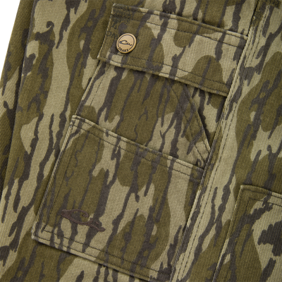 Close-up of the Drake Throwback80 Field Pant's camo fabric, featuring a patch pocket with a snap button, highlighting its rugged design and durable craftsmanship.
