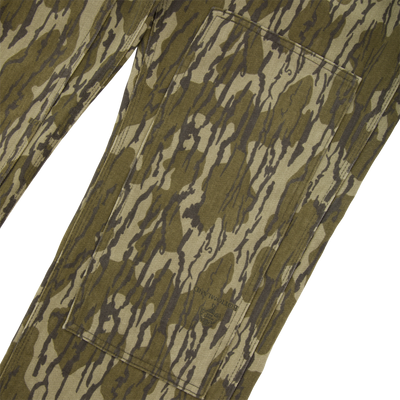Close-up of Throwback80 Field Pant showing the camo pattern, cargo pocket, and triple-needle stitching, highlighting its durable construction and rugged design for outdoor activities.