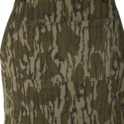 Close-up of Throwback 80 Field Bib's olive-green camo fabric with PRADA logo on pocket, highlighting its durable construction and traditional workwear style.