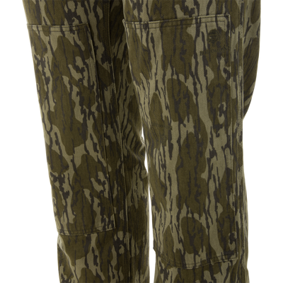 Close-up of Throwback 80 Field Bib, showcasing tiger-stripe camo pattern, patch pockets, and heavy-duty cotton twill for durability. Perfect for rugged outdoor tasks.