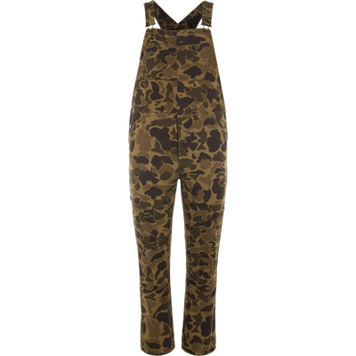 Throwback 80 Field Bib on a mannequin, featuring adjustable straps, front bib pocket, side snap closures, and durable construction with triple-needle stitching and knee reinforcements.