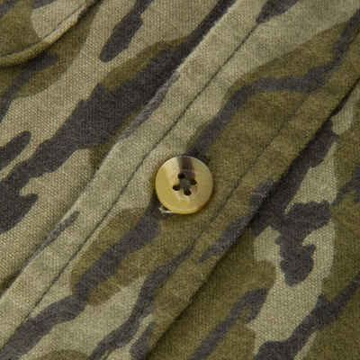 Close-up of the Throwback 80 Button Down Shirt showcasing a camouflage-patterned fabric with a plastic button, highlighting its durable cotton twill construction and reinforced stitching.