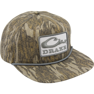 Drake X LOST Goat Rope Cap featuring a camouflage pattern, flat brim, snap-back closure, and a stylized Drake logo with rope detail above the bill.