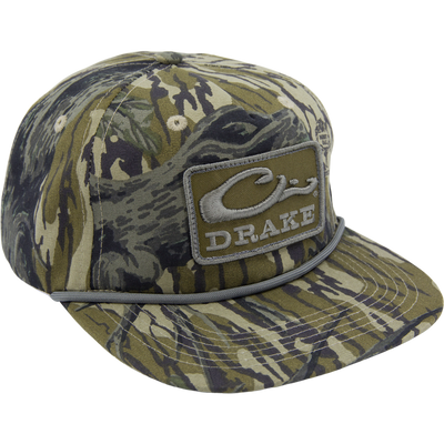 Drake X Lost Hat Goat Rope Cap featuring a camo pattern, stylized DRAKE patch, and paracord rope detail, offering rugged style and customizable fit.