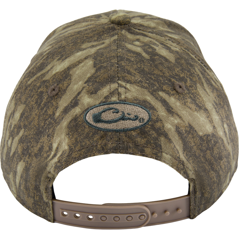 Back view of the Side Logo Cap, featuring a camouflage pattern, oval logo, and adjustable tan snap-strap closure, highlighting Drake Waterfowl's quality craftsmanship.