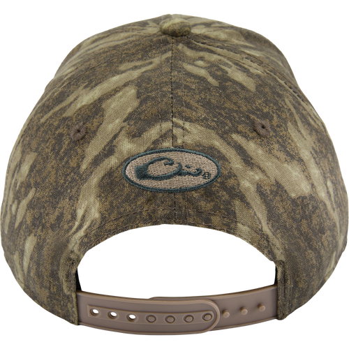 Back view of the Side Logo Cap, featuring a camouflage pattern, oval logo, and adjustable tan snap-strap closure, highlighting Drake Waterfowl's quality craftsmanship.
