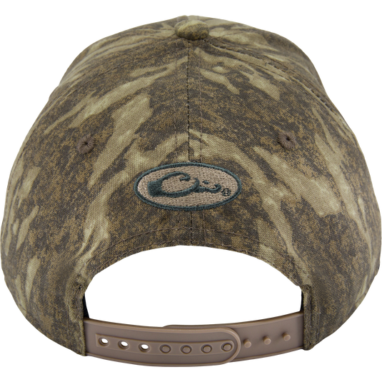 Back view of the Side Logo Cap, featuring a camouflage pattern, oval logo, and adjustable tan snap-strap closure, highlighting Drake Waterfowl's quality craftsmanship.