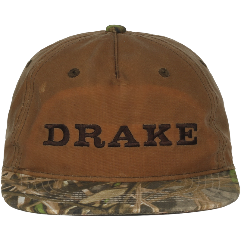 Waxed Flatbill Ball Cap with DRAKE embroidery, featuring a brown canvas crown and camouflage brim, offering a stylish, unstructured fit for outdoor enthusiasts.