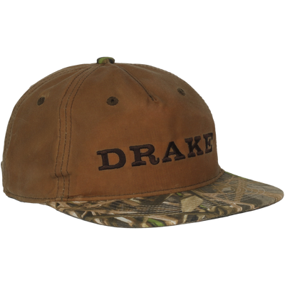 Waxed Flatbill Ball Cap featuring DRAKE embroidery, solid brown canvas crown, and camouflage-patterned flat brim, designed for comfort with a mid crown and unstructured fit.