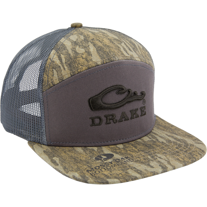 Drake X LOST SA7AGE 7 Panel Cap with camo front, mesh sides, and stitched logo. Features structured silhouette, snap-back closure, and mid-crown profile for versatile wear.