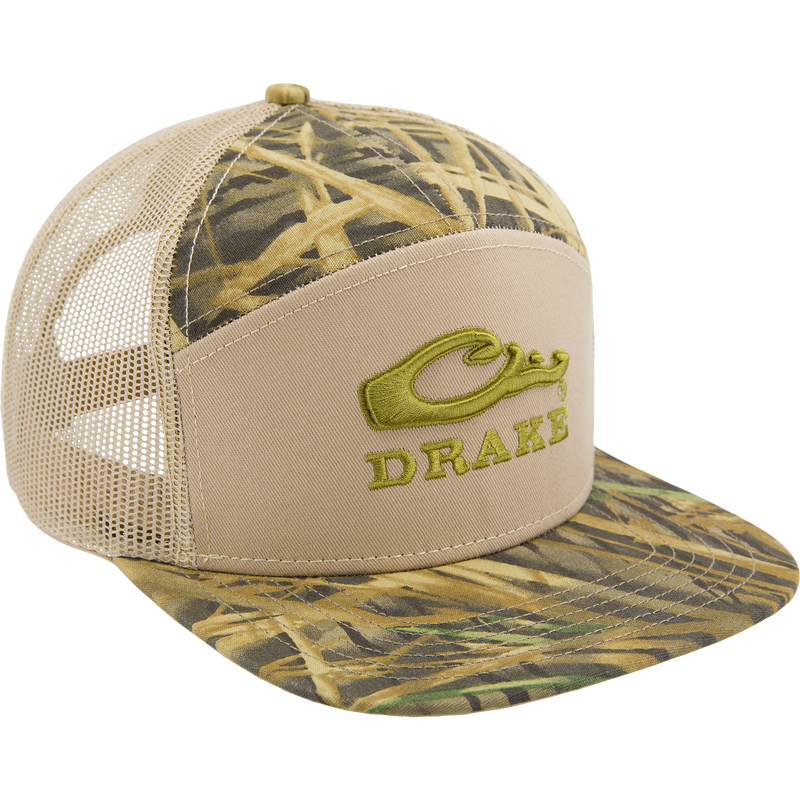 Drake X LOST SA7AGE 7 Panel Cap with tan front, green logo, camo print, beige mesh back, and snap-back closure for a modern hunting-inspired style.