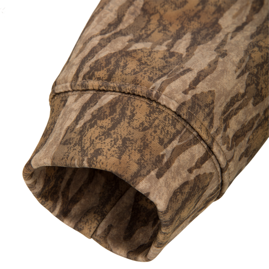 Close-up of the Youth Performance Hoodie's camo cuff, highlighting the durable seam stitching and tiger-stripe pattern, showcasing its resilience and flexibility for active wear.