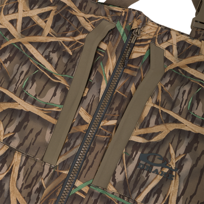 Close-up of the BMF Uninsulated Pit Bib, showcasing rip-stop camo fabric, central zipper, seam details, and reinforced panels, emphasizing durability and performance for harsh conditions.