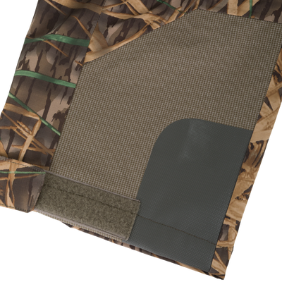 BMF Uninsulated Pit Bib featuring camo-print textile assembly with mesh lining, anti-slip rubber panel, and Velcro strip, designed for durability and performance in harsh conditions.