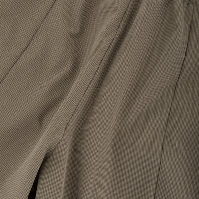 Close-up of BMF Uninsulated Pit Bib's brownish-beige fabric with a fine white grid pattern, showcasing its durable, waterproof, and breathable 3-layer stretch ripstop material.