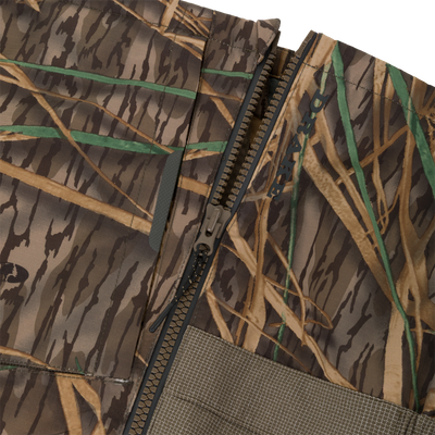 Close-up of the BMF Uninsulated Pit Bib showing ripstop fabric, heavy-duty zipper, and Velcro pocket, highlighting durable, waterproof, and windproof features for hunting and tactical use.