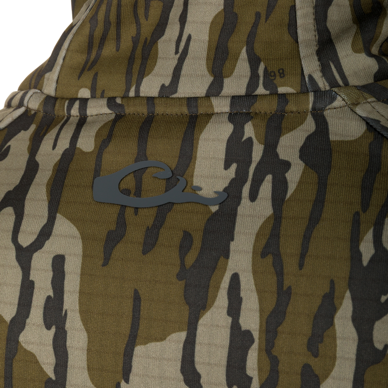 Camouflage fabric of Grid Fleece Half Zip Hoodie, featuring visible stitching, pocket seam, and dark-gray C logo, highlighting its durable, moisture-wicking design.