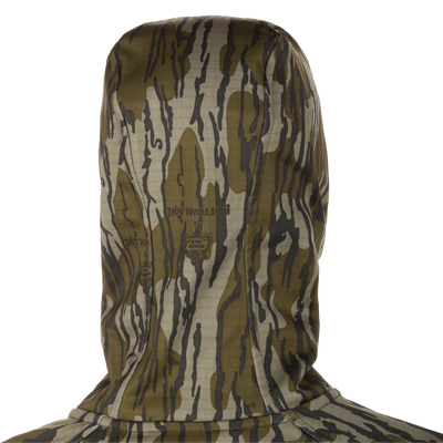 Grid Fleece Half Zip Hoodie in Bottomland Mossy Oak camo, showing back, hood, and faint logo. Features include moisture-wicking grid-fleece, stretch fabric, and water-resistant pocket.