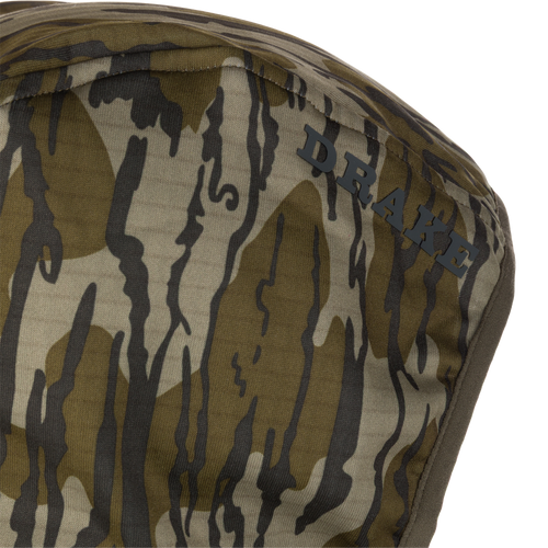 Close-up of the Grid Fleece Half Zip Hoodie with DRAKE logo, showcasing its camouflage pattern and moisture-wicking, stretchable fleece material for hunting comfort.