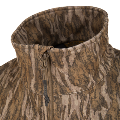 Close-up of the MST CommandXT Softshell Vest's camo high collar and front zipper, highlighting its durable stitching and flexible, weather-resistant fabric.