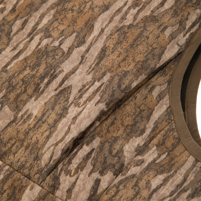 Close-up of MST CommandXT Softshell Vest, showcasing its brown camouflage-patterned fabric and stitching, emphasizing its durable, windproof, and water-resistant design for outdoor use.
